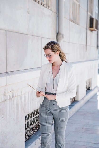 Pretty businesswoman looking at tablet