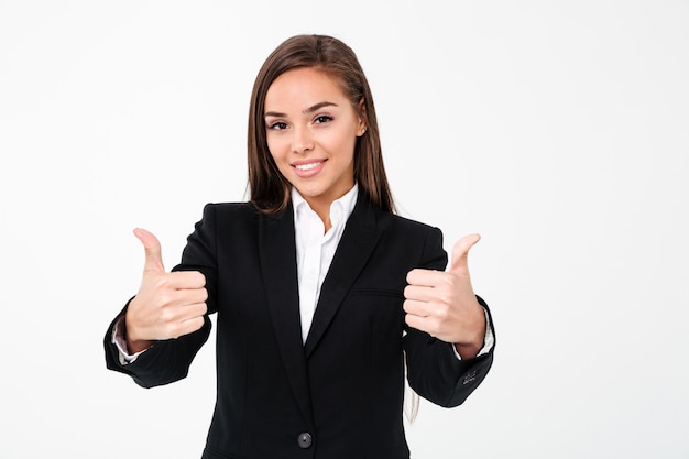 Pretty cheerful business woman showing thumbs up