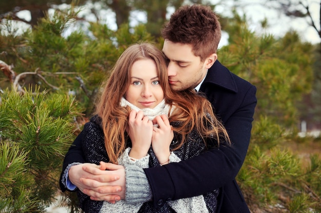 Free photo pretty couple hugging and flirting on a winter day