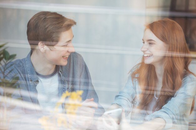 Pretty couple sitting in cafe