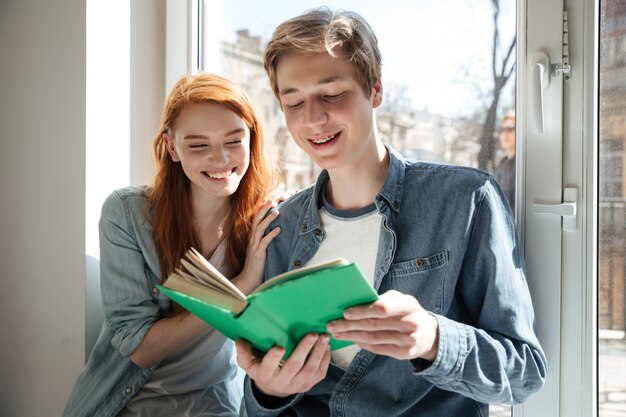 Pretty couple of students reading book