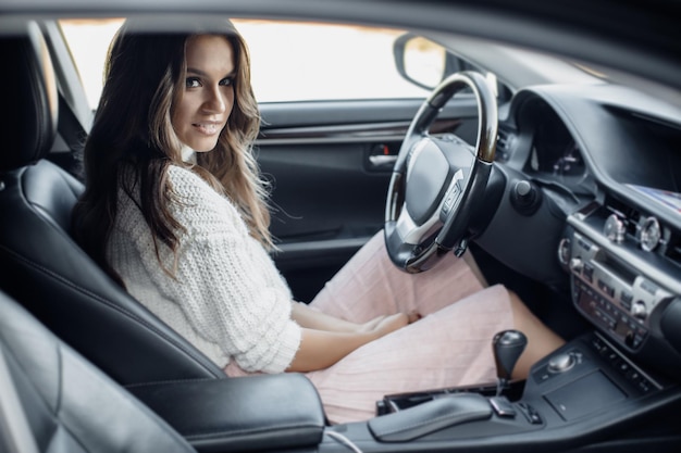 Free photo pretty cozy woman in car