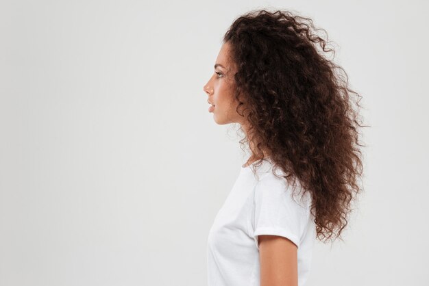 Pretty curly woman posing in profile