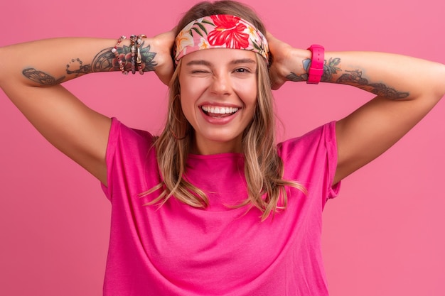 Pretty cute smiling woman in pink shirt boho hippie style accessories smiling emotional fun posing on pink isolated