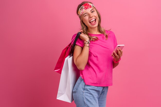 Pretty cute smiling woman in pink shirt boho hippie style accessories smiling emotional fun posing on pink isolated