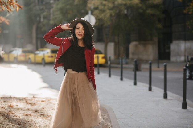 Pretty dark-haired woman in stylish long skirt chilling in park