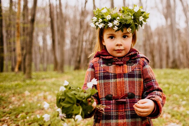 The pretty daughter has a wreath and bouquet  of snowdrops  