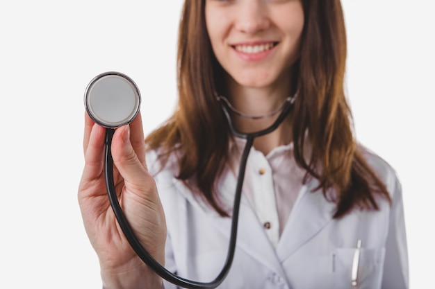 Pretty doctor listening with stethoscope