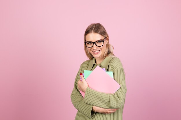 Pretty european woman in casual sweater on pink wall