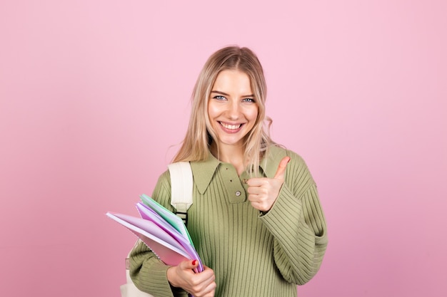 Pretty european woman in casual sweater on pink wall