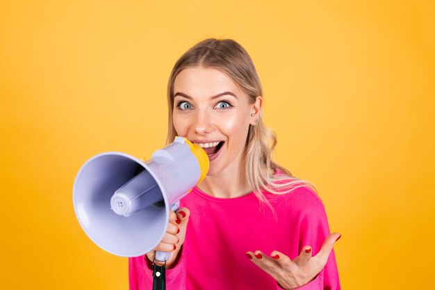 Pretty european woman in pink blouse on yellow wall