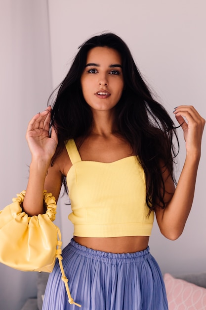 pretty fashion blogger woman wearing yellow top and purple pants