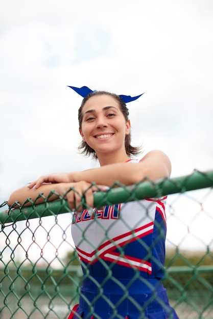 Pretty female cheerleader in cute uniform