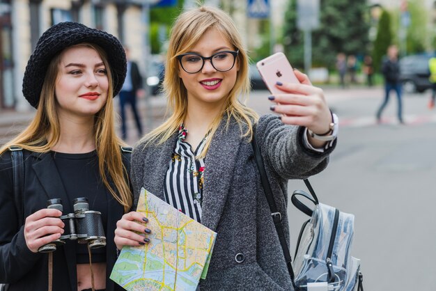 Pretty female tourists taking selfie