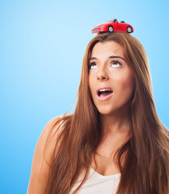 Pretty female with a little car on her head
