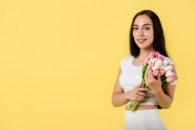 Pretty female with white and pink tulips