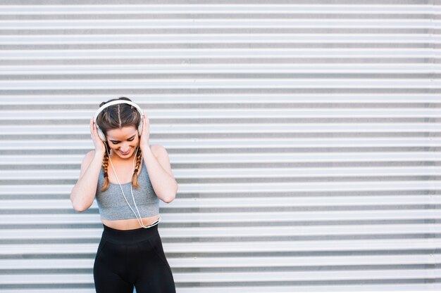 Pretty fit woman in headphones