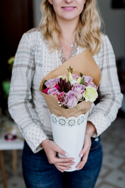 Pretty florist with bunch of flowers