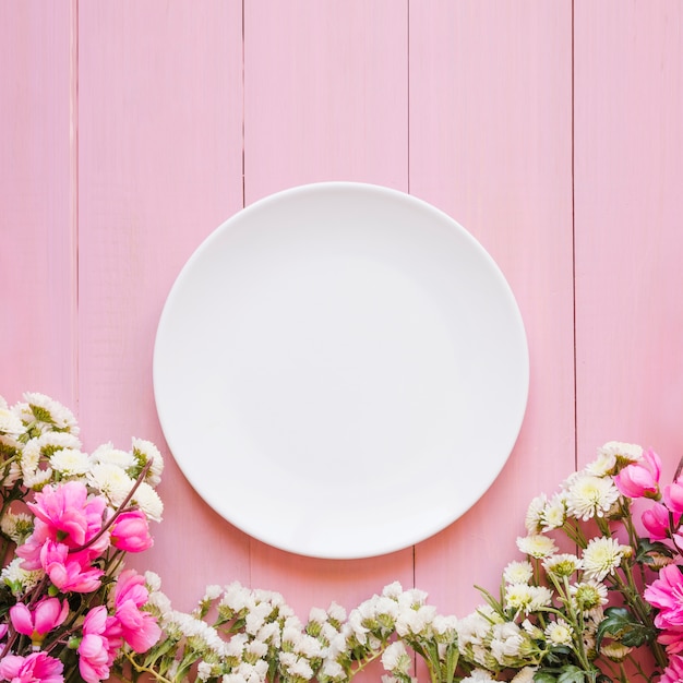 Pretty flowers near plate