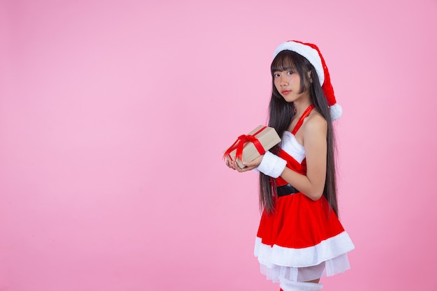 pretty girl in christmas costume holding christmas gift