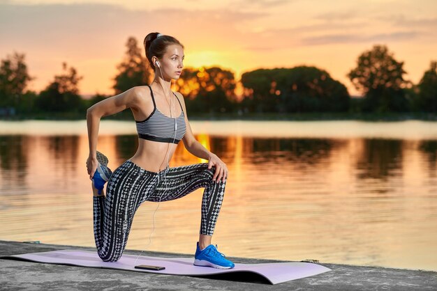 Pretty girl doing stretch exercises for perfect figure