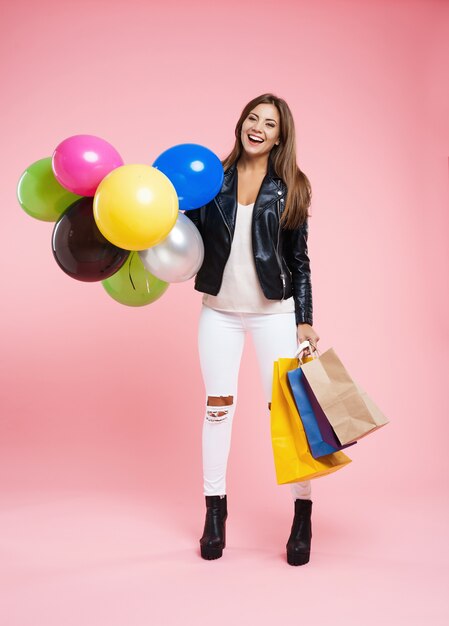 Pretty girl in fashion leather jacket, ripped jeans, ankle boots