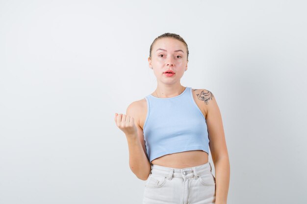 pretty girl is showing her hand on white background