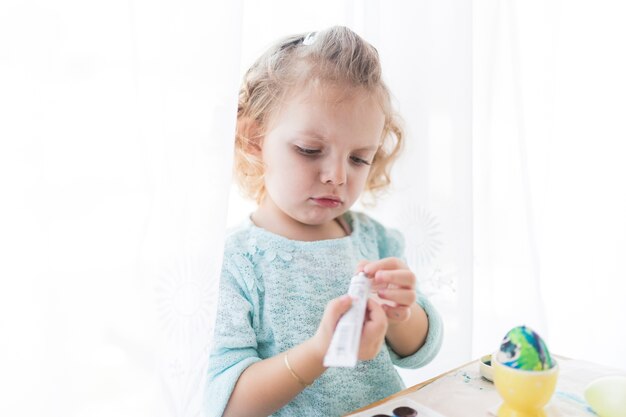 Pretty girl looking at paint