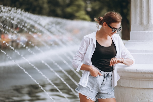 Pretty girl in park by the fountains