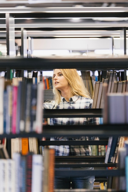 Free photo pretty girl picking books