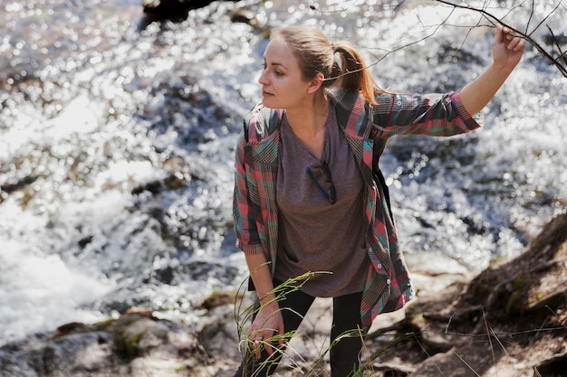 Foto gratuita bella ragazza in posa con lo sfondo del fiume