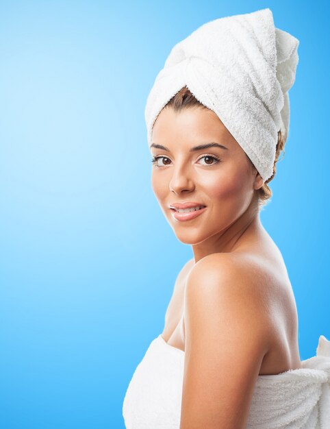 Pretty girl in towel smiling at camera