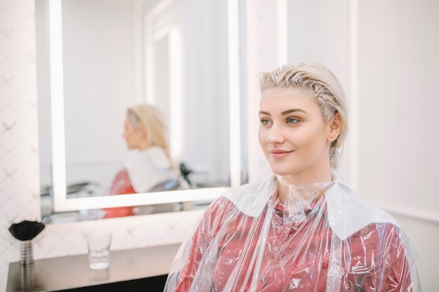 Free photo pretty girl waiting for hair coloring