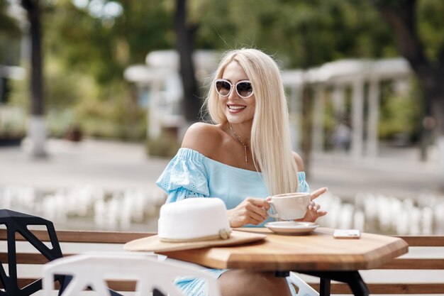 pretty girl with coffee cup in terrace cafe