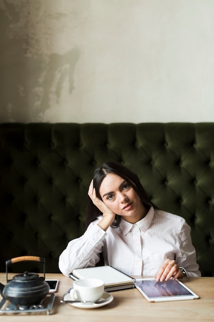 Pretty girl with studies in cafeteria