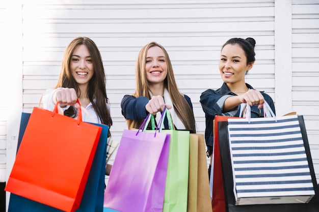 Pretty girls showing shopping bags