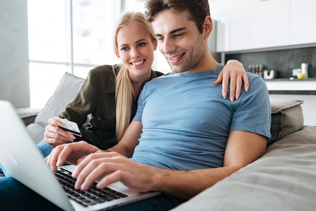 Free photo pretty handsome man and woman using laptop computer