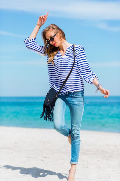 Pretty happiness young woman laughing and having fun on the sunny beach