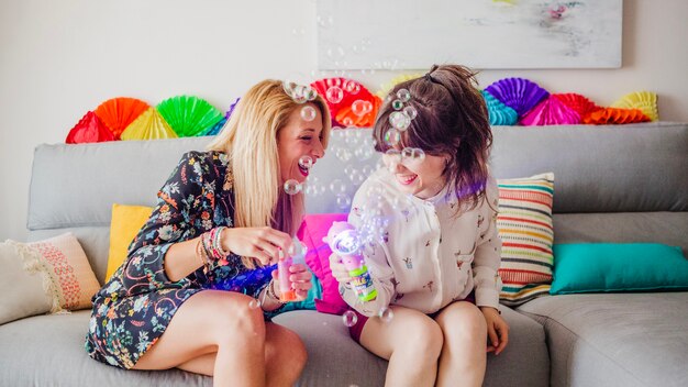 Free photo pretty happy women with bubbles