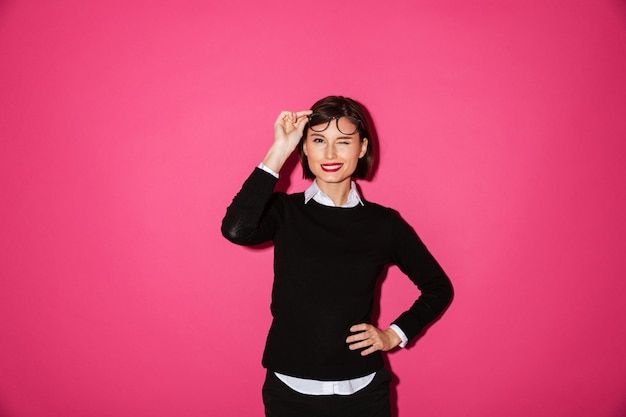 Free photo pretty lady taking off her glasses and winking isolated