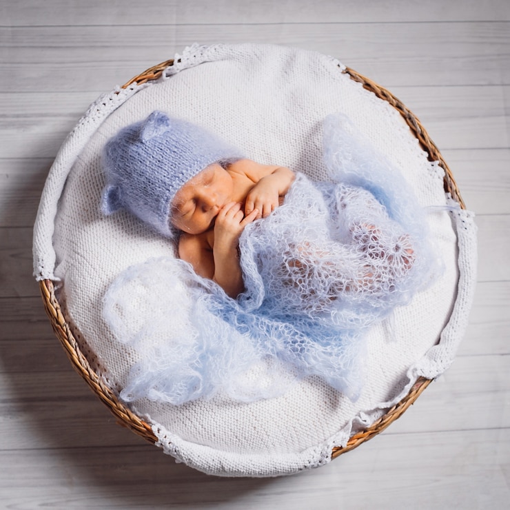 Free Photo pretty little child sleeps on fluffy pillow on blue background 