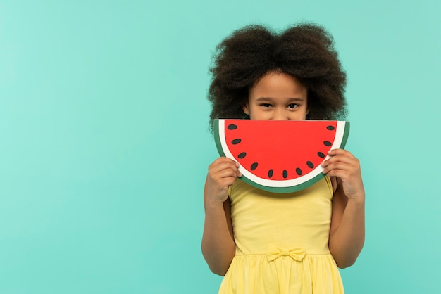 Pretty little girl having fun in a summer setting studio