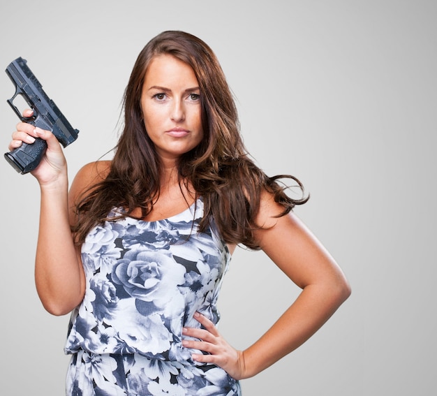 Free photo pretty mafia woman holding a gun