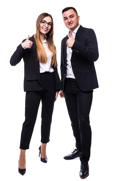 Pretty man and woman in black suite show thumbs up sign on white