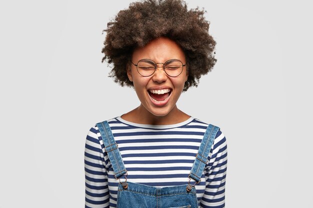 Pretty mixed race female model laughs happily