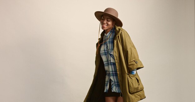 Pretty mixed race woman with short hair in autumn outwear and hat