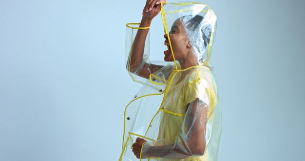 Pretty mixed race woman with short hair in transparent raincoat