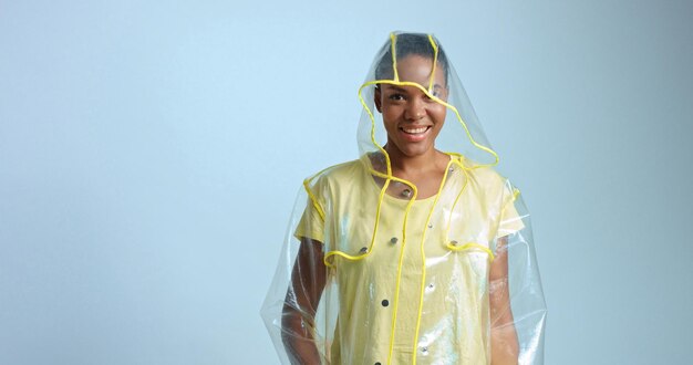 Pretty mixed race woman with short hair in transparent raincoat