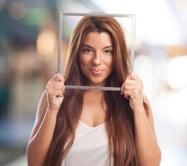 Pretty model posing with photo frame