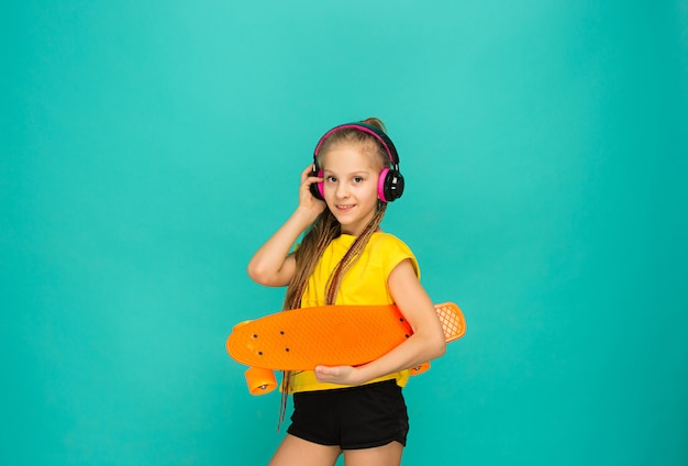 Pretty skater girl holding skateboard